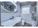 Bright bathroom featuring a stone accent wall, marble countertop, and sleek fixtures at 3127 Mill Se St, Covington, GA 30014