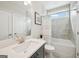 Well-lit bathroom featuring a shower-tub combo, neutral tiling, and a vanity with a white countertop at 401 Hallman Pl, Peachtree City, GA 30269
