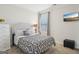 Cozy bedroom with patterned bedding, a mounted flatscreen and bright natural light at 401 Hallman Pl, Peachtree City, GA 30269