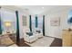 Bright sitting area with dual white reclining chairs, blue pillows and modern art at 401 Hallman Pl, Peachtree City, GA 30269