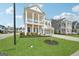 Beautifully landscaped lawn and view of the charming two-story home with double front porches at 401 Hallman Pl, Peachtree City, GA 30269