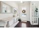 Bright foyer with dark hardwood floors, white walls, decorated table, and a decorative mirror at 401 Hallman Pl, Peachtree City, GA 30269