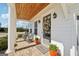 Inviting front porch with rocking chairs, brick floor, and a wooden ceiling adding warmth at 401 Hallman Pl, Peachtree City, GA 30269