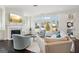 Bright living room features large windows, a fireplace, and comfortable seating creating a cozy atmosphere at 401 Hallman Pl, Peachtree City, GA 30269