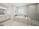 Bright bathroom features soaking tub, walk-in shower, and double vanity at 401 Hallman Pl, Peachtree City, GA 30269