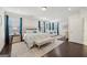 Elegant main bedroom with a tufted headboard, bench, sitting area and dark hardwood floors at 401 Hallman Pl, Peachtree City, GA 30269