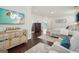 Spacious primary bedroom featuring hardwood floors, sitting area and large mounted flatscreen TV at 401 Hallman Pl, Peachtree City, GA 30269