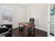 Home office space with wooden desk, dark hardwood floors, and natural light at 401 Hallman Pl, Peachtree City, GA 30269