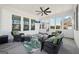 Relaxing sunroom with neutral walls, leafy area rug, wicker furniture, and views of the outdoor patio area at 401 Hallman Pl, Peachtree City, GA 30269