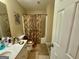 Standard bathroom featuring neutral colors, tiled floor, and tub with shower at 25 Horseshoe Ct, Covington, GA 30014