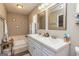 Bathroom featuring a double sink vanity, large soaking tub, and decorative wall decor at 11157 Ash Ct, Hampton, GA 30228