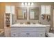 Bathroom with a white double sink vanity and two large mirrors with vanity lighting at 11157 Ash Ct, Hampton, GA 30228