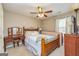 Cozy bedroom featuring a wooden vanity, a large bed, and neutral carpet at 11157 Ash Ct, Hampton, GA 30228