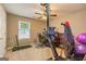 Carpeted exercise room with a ceiling fan, desk, and stained glass window at 11157 Ash Ct, Hampton, GA 30228