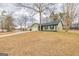 Quaint green ranch home with well-maintained lawn and mature trees in a country setting at 11157 Ash Ct, Hampton, GA 30228