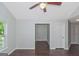 Bedroom with wood floors, ceiling fan and view into another room at 473 Tufton Se Trl, Atlanta, GA 30354