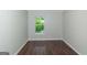 Empty bedroom features wood floors, and double hung window with tree views at 473 Tufton Se Trl, Atlanta, GA 30354