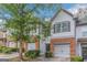 Charming townhouse featuring a brick facade, single-car garage, and well-maintained landscaping at 473 Tufton Se Trl, Atlanta, GA 30354