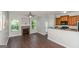 Open-concept area featuring hardwood floors, fireplace, and adjacent eat-in kitchen at 473 Tufton Se Trl, Atlanta, GA 30354