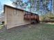 Exterior view of home with a wooden deck and stairs leading to the backyard at 2930 David Ne Ln, Conyers, GA 30012