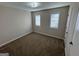 Cozy bedroom with neutral paint, plush carpet, and sunlit windows at 2930 David Ne Ln, Conyers, GA 30012