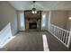 Cozy living room with a stone fireplace, large windows, and neutral-toned carpet at 2930 David Ne Ln, Conyers, GA 30012