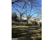 Spacious, fenced backyard featuring mature trees and a well-maintained lawn, perfect for outdoor living at 5725 Lake Windsor Pkwy, Buford, GA 30518