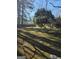 Large backyard with mature trees and grass at 5725 Lake Windsor Pkwy, Buford, GA 30518