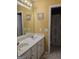 Bright bathroom featuring a double sink vanity and a separate shower area with patterned curtain at 5725 Lake Windsor Pkwy, Buford, GA 30518