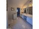Bathroom with double vanity, linen closet and a framed mirror with a dressing table at 5725 Lake Windsor Pkwy, Buford, GA 30518