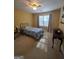 Bedroom with carpeted floors and a ceiling fan features a window for plenty of natural light at 5725 Lake Windsor Pkwy, Buford, GA 30518