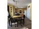 Kitchen dining area boasts wood-look floors, a black dining set, and warm, light wood cabinets at 5725 Lake Windsor Pkwy, Buford, GA 30518