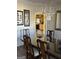 Dining room with elegant chandelier, mirror, and view into the kitchen with wood cabinets at 5725 Lake Windsor Pkwy, Buford, GA 30518