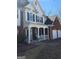 Lovely two-story home featuring a combination of brick and siding with an inviting, covered front porch at 5725 Lake Windsor Pkwy, Buford, GA 30518