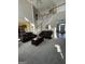 Bright living room features soaring ceilings, an open staircase and comfortable leather furnishings at 5725 Lake Windsor Pkwy, Buford, GA 30518