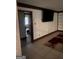 Living Room featuring stylish paneling, a mounted TV, and hardwood flooring at 392 Hwy 314, Fayetteville, GA 30214