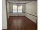 Well-lit dining room with hardwood floors, classic wainscoting, and a modern chandelier at 392 N Hwy 314, Fayetteville, GA 30214