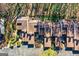 An aerial view of townhomes with landscaped yards, surrounded by mature trees at 62 Cobblestone Crk, Peachtree City, GA 30269