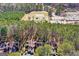An aerial view of townhomes and the community school surrounded by mature trees at 62 Cobblestone Crk, Peachtree City, GA 30269