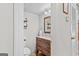 Well-lit half bathroom with a classic vanity, framed mirror, and modern fixtures at 62 Cobblestone Crk, Peachtree City, GA 30269