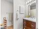 Bathroom featuring wooden vanity with a white countertop and decorative wall accents at 62 Cobblestone Crk, Peachtree City, GA 30269
