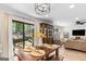 Bright dining area featuring a rustic wood table, modern lighting, and backyard access at 62 Cobblestone Crk, Peachtree City, GA 30269