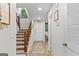 Well-lit hallway with hardwood floors and staircase leading upstairs at 62 Cobblestone Crk, Peachtree City, GA 30269