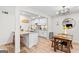 Bright kitchen with white cabinetry, granite countertops, an island, and a stainless steel sink at 62 Cobblestone Crk, Peachtree City, GA 30269