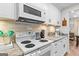 Cozy kitchen with stone countertops, stainless steel appliances, and classic white cabinetry at 62 Cobblestone Crk, Peachtree City, GA 30269