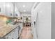 Bright kitchen with stainless steel appliances, granite countertops, and an open view to the dining room at 62 Cobblestone Crk, Peachtree City, GA 30269