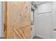 Functional laundry room with stacked washer and dryer, and barn door at 62 Cobblestone Crk, Peachtree City, GA 30269