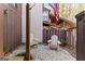 Cozy patio space with two white Adirondack chairs on white gravel with American flag in background at 62 Cobblestone Crk, Peachtree City, GA 30269