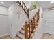 Bright stairway with carpeted steps, wooden railing and side decor at 62 Cobblestone Crk, Peachtree City, GA 30269
