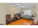 Bedroom featuring two arm chairs, ceiling fan, and a bed with green quilt at 2615 Hampton Locust Grove Rd, Locust Grove, GA 30248